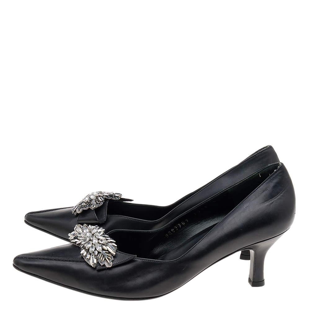 These Salvatore Ferragamo pumps are fabulously designed to make you look nothing less than a diva! The black pumps are crafted from leather and artistically embellished for an opulent finish. Low heels and pointed-toes complete these beauties.


