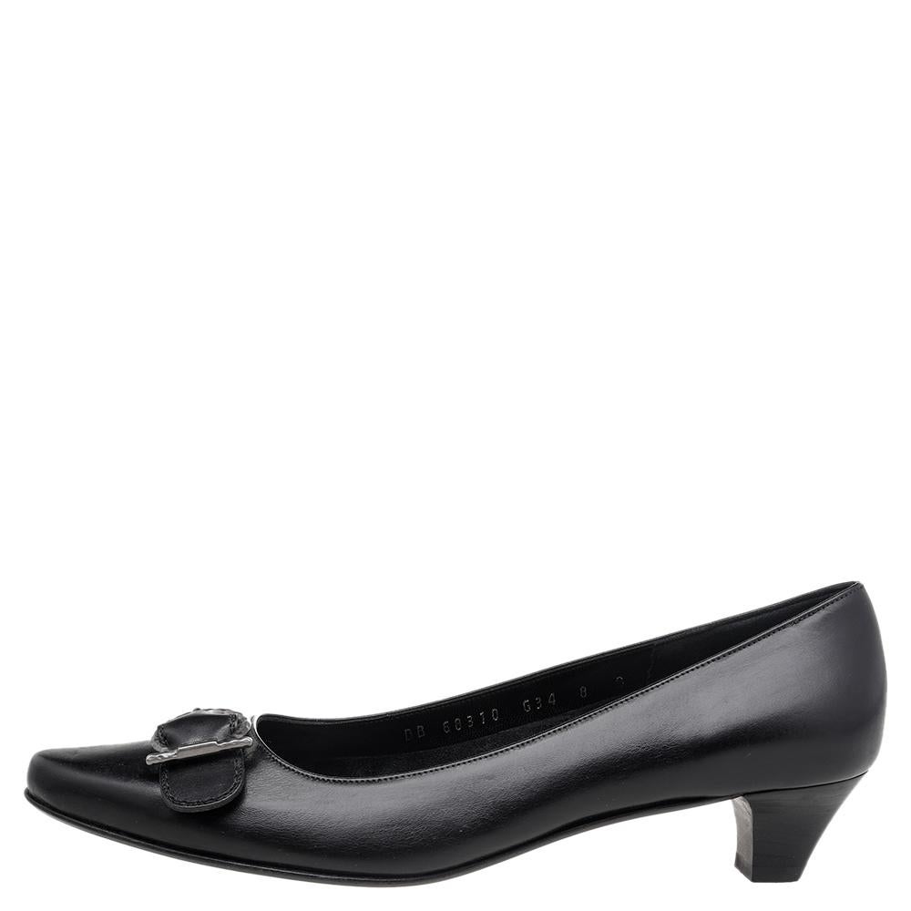 Endless compliments will come your way every time you wear these Salvatore Ferragamo pumps. The black pumps are crafted from leather and styled with almond toes, the signature Gancini detail on the uppers, and block heels. They are complete with