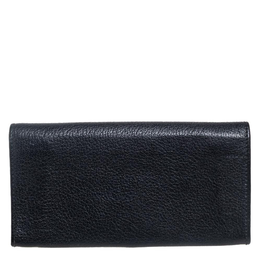 Crafted from leather, this continental wallet from Salvatore Ferragamo carries the signature Gancini motif on the front flap and a black hue. The flap opens to a functional interior equipped with multiple slots and a zipped compartment to carry your