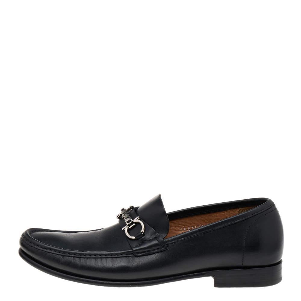 These classy loafers from the House of Salvatore Ferragamo will bring sophistication and class to your appearance. They are made from black leather on the exterior, with a silver-toned Gancio motif perched on their vamps. These loafers are designed