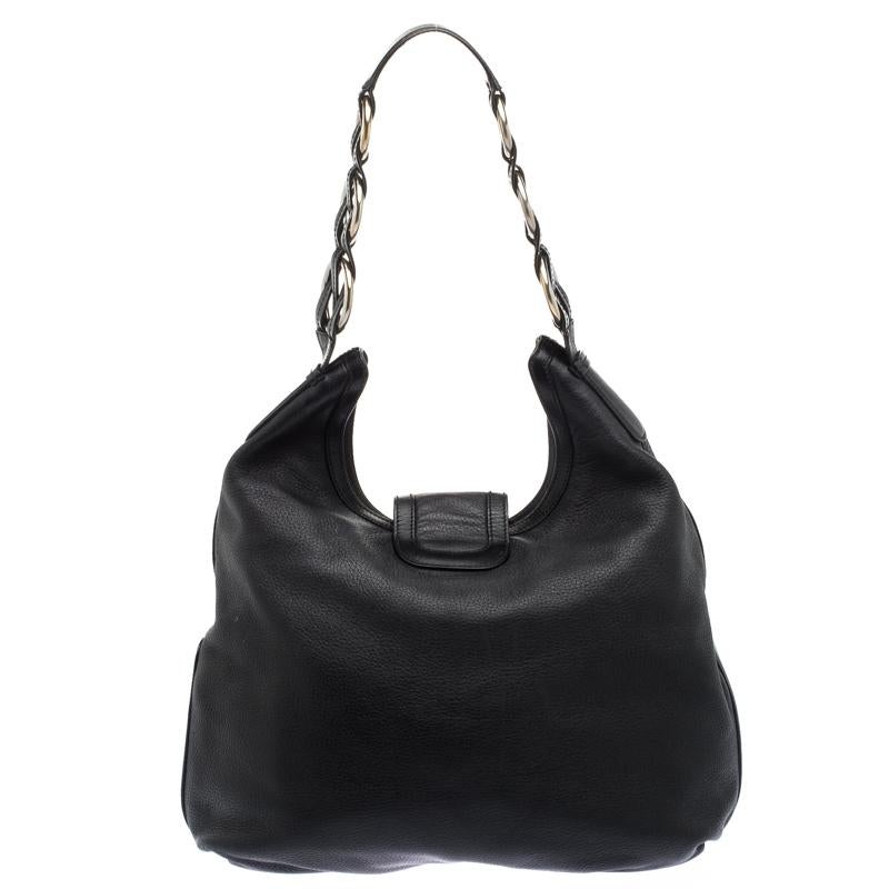 Ideal for everyday use, this hobo is a Salvatore Ferragamo design. It is made from leather and it flaunts a black hue with a flap carrying a logo buckle and leading way to a spacious fabric interior. The lovely bag is complete with a single handle