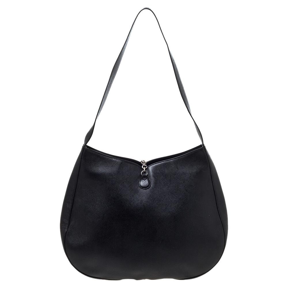 This bag by Salvatore Ferragamo is an ideal option for keeping your daily essentials safe. Lined with fabric and held by a single handle, this hobo is ideal for everyday use. Comfortable and easy to carry, this black leather bag is a must-have.

