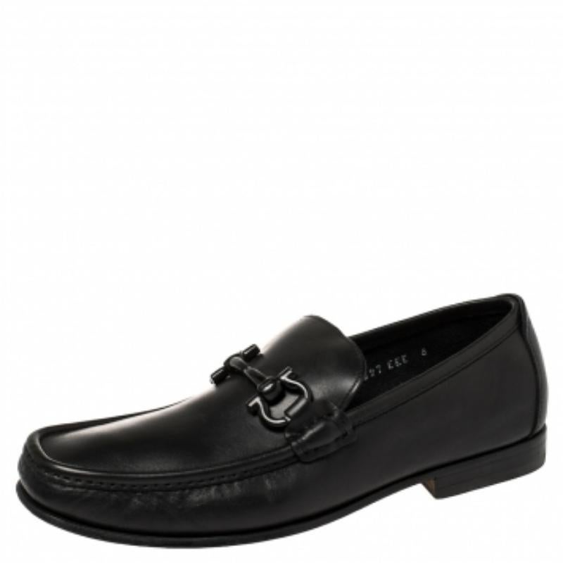 These black loafers by Salvatore Ferragamo are a result of skillful craftsmanship and luxurious design. They have been crafted using quality leather and designed with beauty using neat stitching and the signature logo on the uppers. The loafers