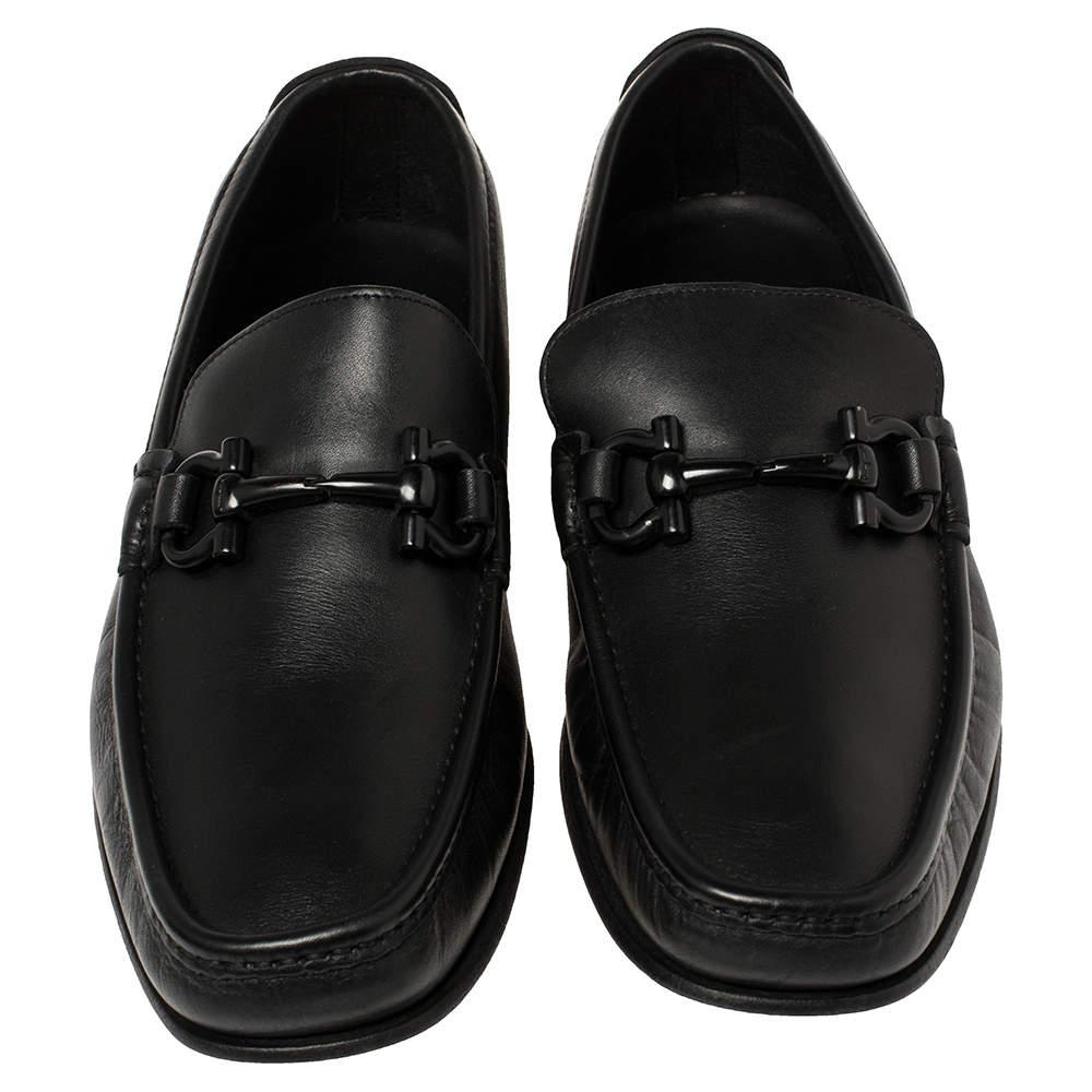 These black loafers by Salvatore Ferragamo are a result of skillful craftsmanship and luxurious design. They have been crafted using quality leather and designed with beauty using neat stitching and the signature logo on the uppers. The loafers