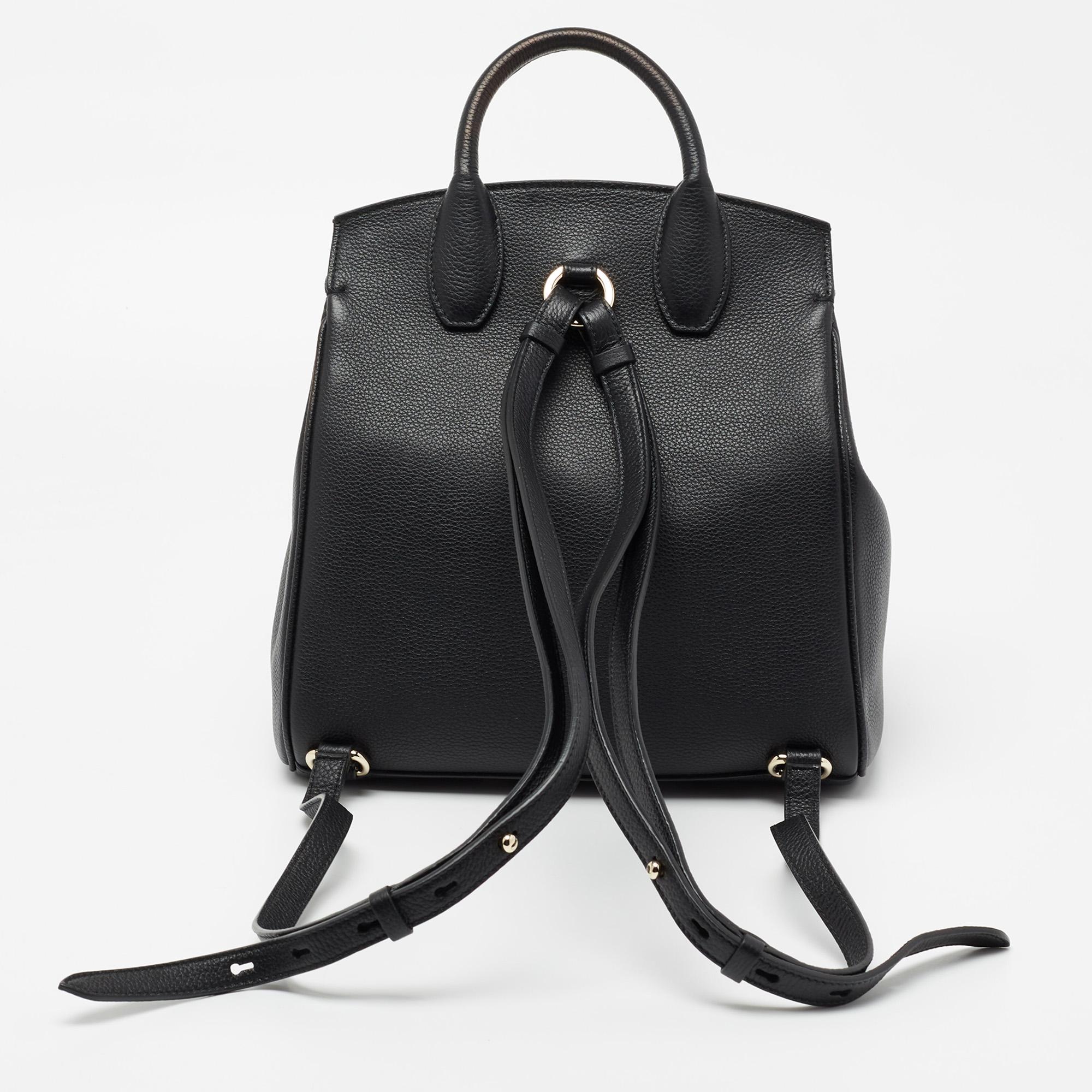 Simple and classy in black, this Salvatore Ferragamo backpack signifies sophistication in its every detail. The Gancini motif on the front adds a signature touch to it, and it is beautified with gold-tone accents. A leather creation, it is made
