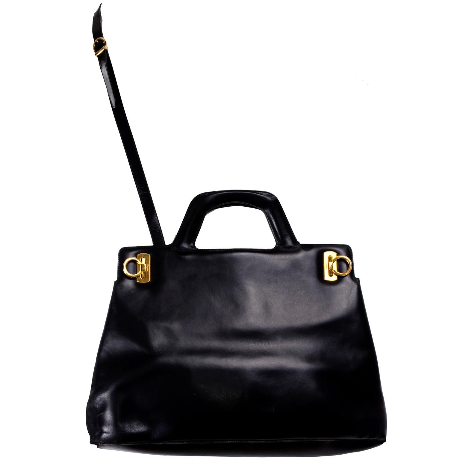 This is a vintage black leather Ferragamo top handle tote style handbag with a shoulder strap. All the gold tone hardware on this great bag is marked with Ferragamo and it has two gold tone loop closures that hinge. Leather tag inside is marked