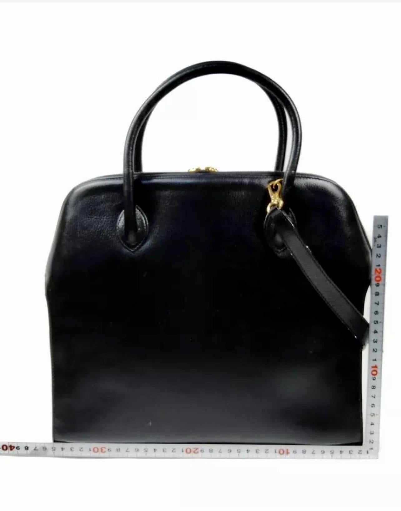 Salvatore Ferragamo Black  Leather Tote / Shoulder Bag Large with Gold Hardware
Ferragamo Black smooth leather tote with  gold chain going from one side to other.
Opens in to a very spacious   two compartment and  and a large zippered pocket. 
Long