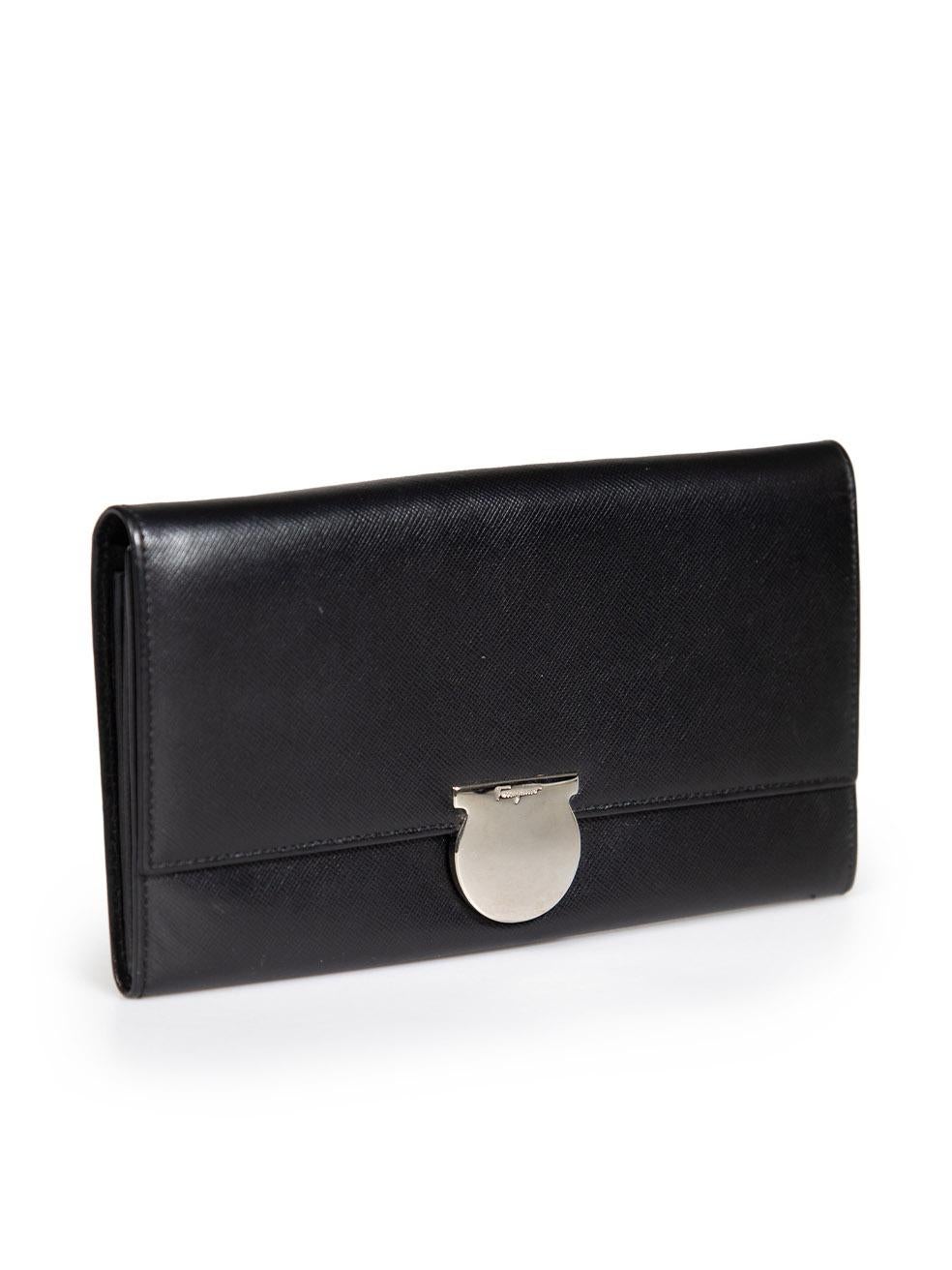 CONDITION is Very Good. Minimal wear to wallet is evident. The hardware has scratches to the outside and tarnishing to the inside and there is a small tear in the right-hand side interior wall on this used Salvatore Ferragamo designer resale item.
