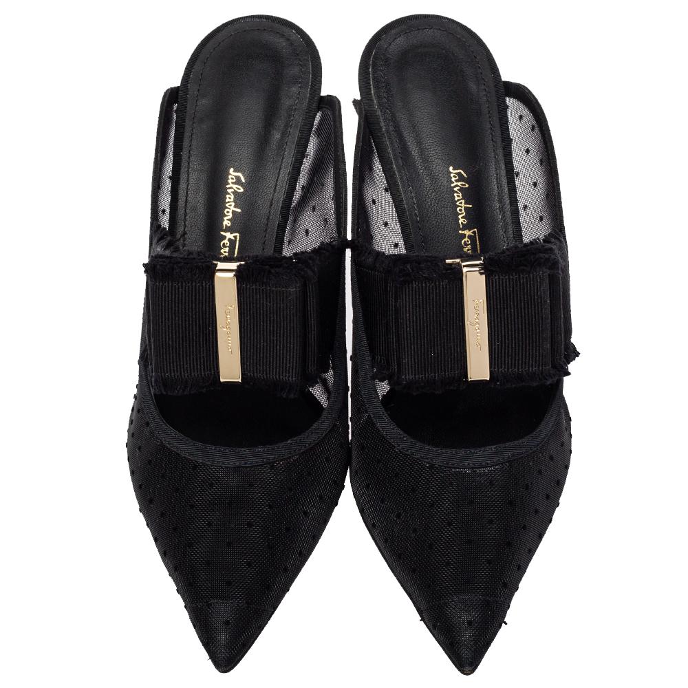 We're greatly impressed by these mule sandals from Salvatore Ferragamo! They are crafted from black mesh and canvas and designed with pointed toes and grosgrain bow details on the vamps. Comfortable leather-lined insoles and 7 cm stiletto heels