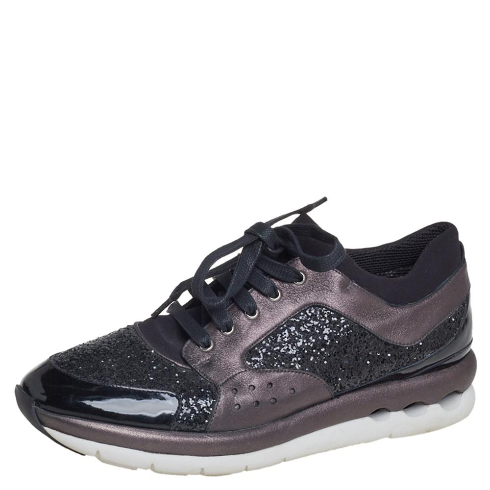 Make a statement everywhere you go by donning these stunning Salvatore Ferragamo sneakers. Crafted in Italy, they are made of quality leather and glitter and come in a combination of black and metallic grey hues. They are styled with lace-up closure