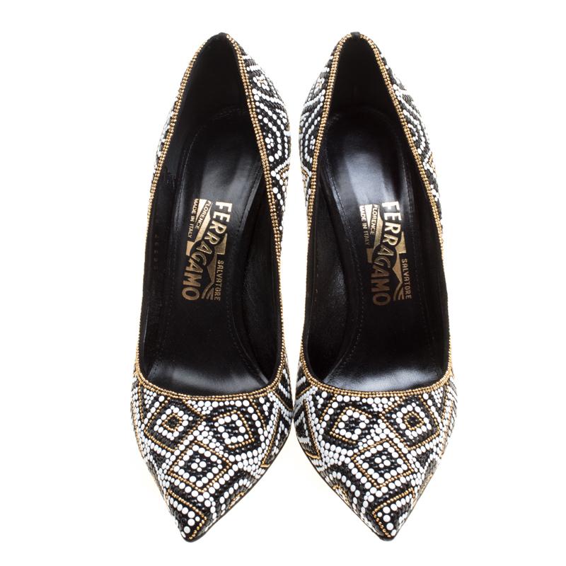 These Salvatore Ferragamo Fiore pumps are fabulously designed to make you look nothing less than a diva! The black pumps are crafted from suede and artistically embellished to create a mosaic pattern all over the exterior. They flaunt pointed toes
