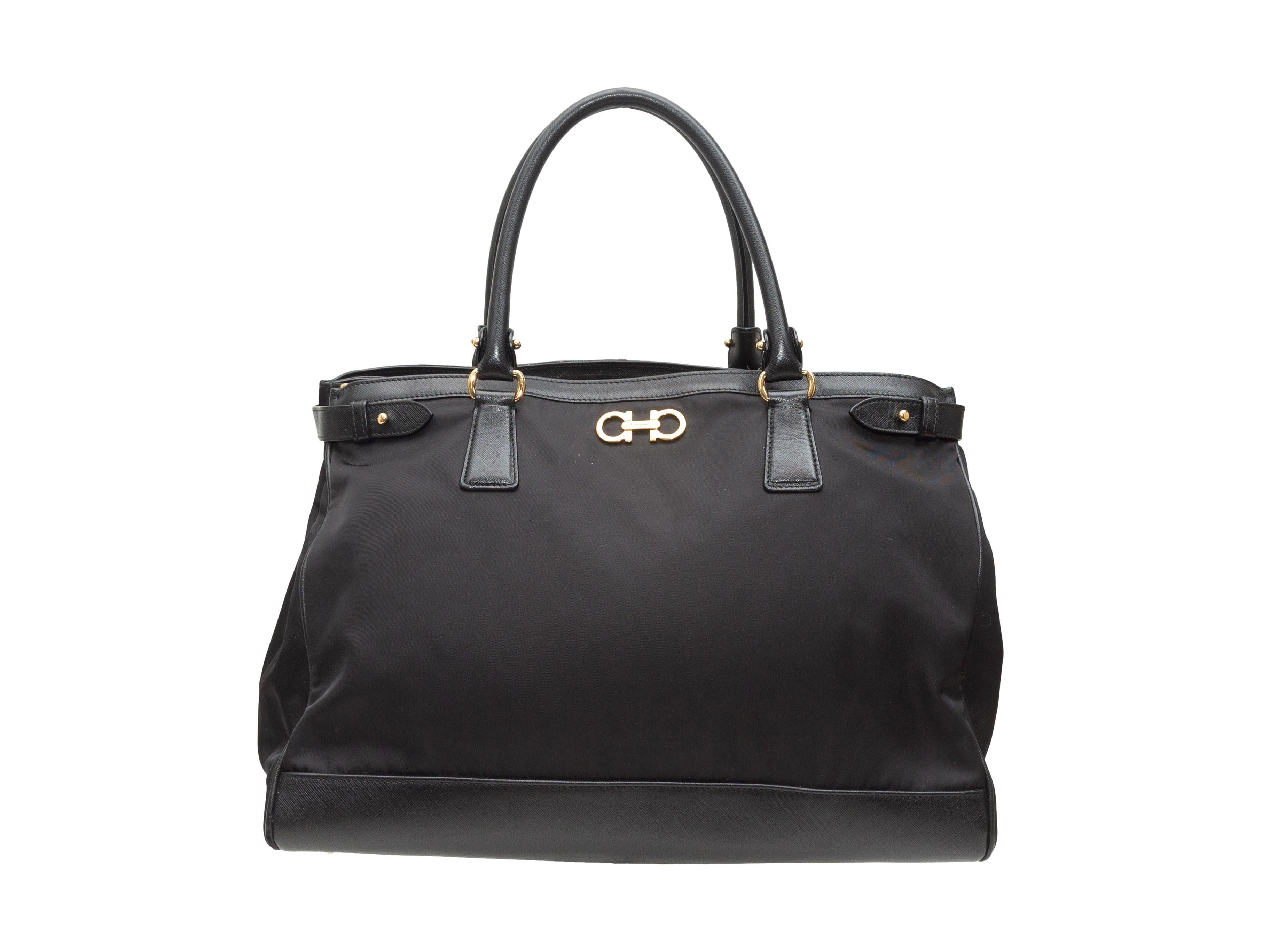 Product details: Black Salvatore Ferragamo Nylon & Leather Handbag. This bag features a nylon body, leather trim, gold-tone hardware, dual rolled top handles, an optional flat shoulder strap, and a zip closure at the top. 15