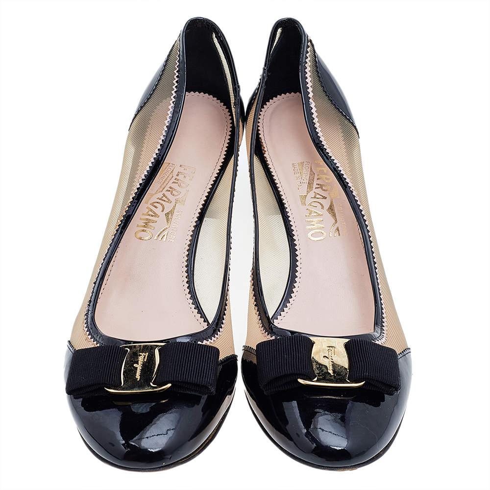 Designed with small heels and a classic color, this pair of Salvatore Ferragamo pumps are perfect for your business looks. Their exterior is made from patent leather and meshes then designed with Vara bows on the toe caps with embossed gold-tone