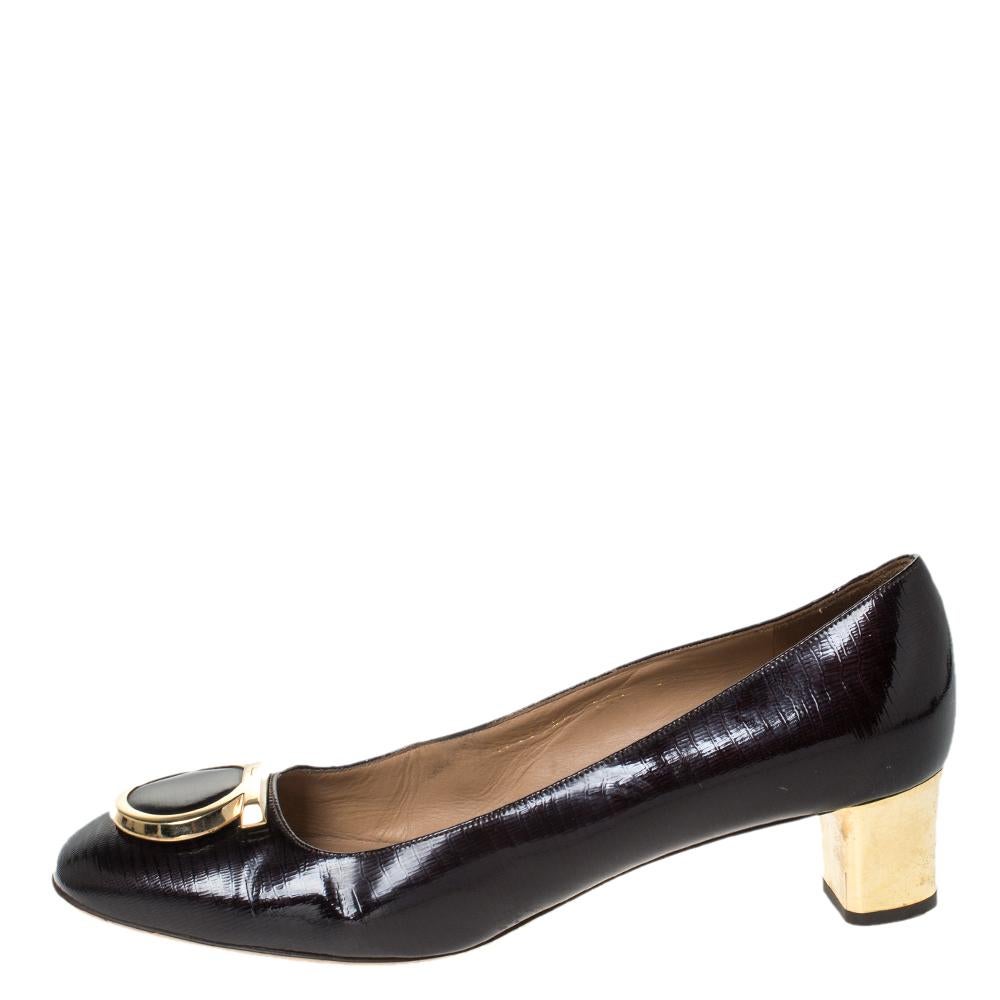 These lovely Fele loafer pumps from Salvatore Ferragamo are crafted from glossy patent leather and feature round toes, gold-tone logo accents on the vamps and contrast stitch detailing. They are equipped with comfortable leather-lined insoles and