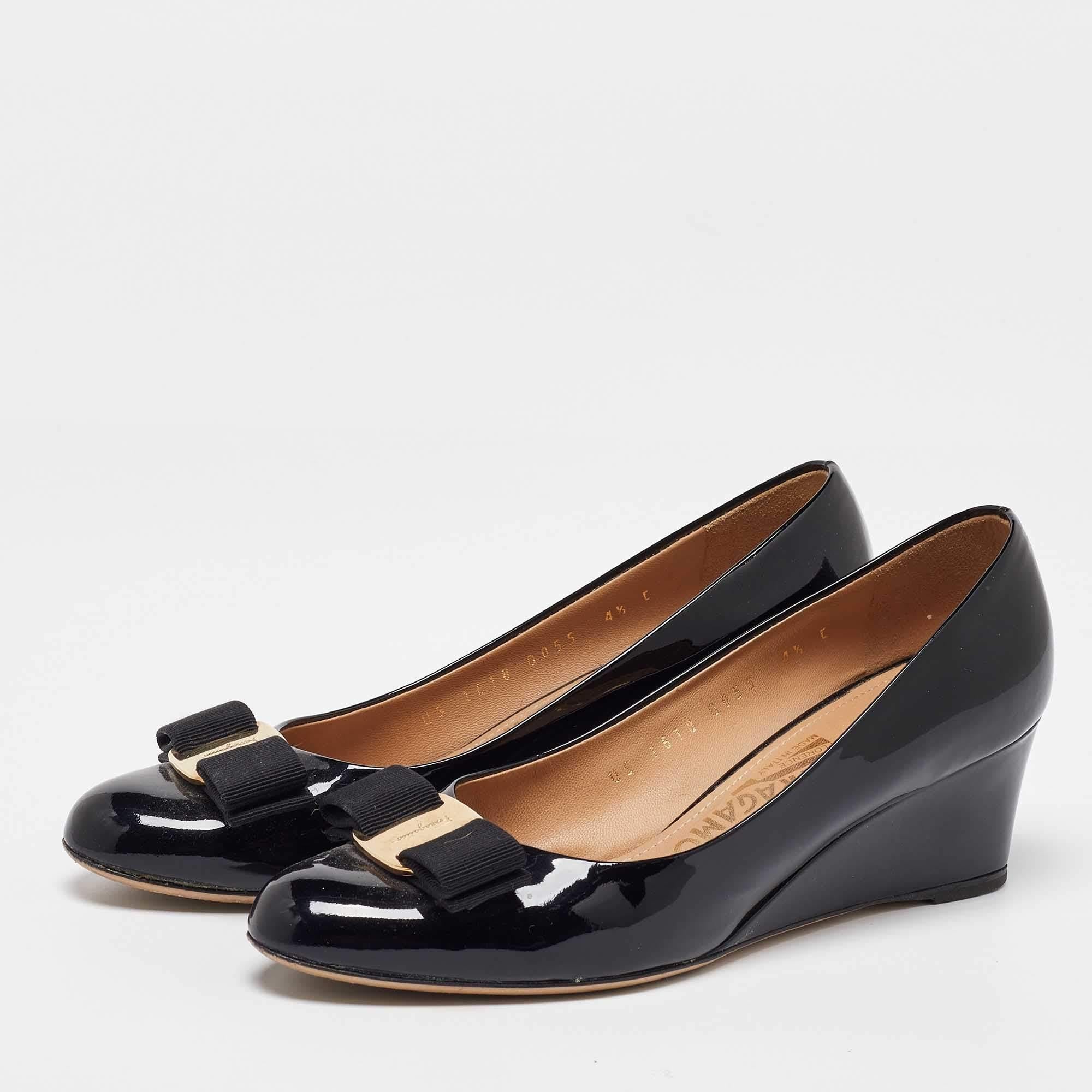 These exquisitely designed pumps are made from patent leather and make an incredibly dressy pair. they feature Vara bows on the uppers durable insoles and wedge heels. Enhance your look by adding these Salvatore Ferragamo pumps to the closet.