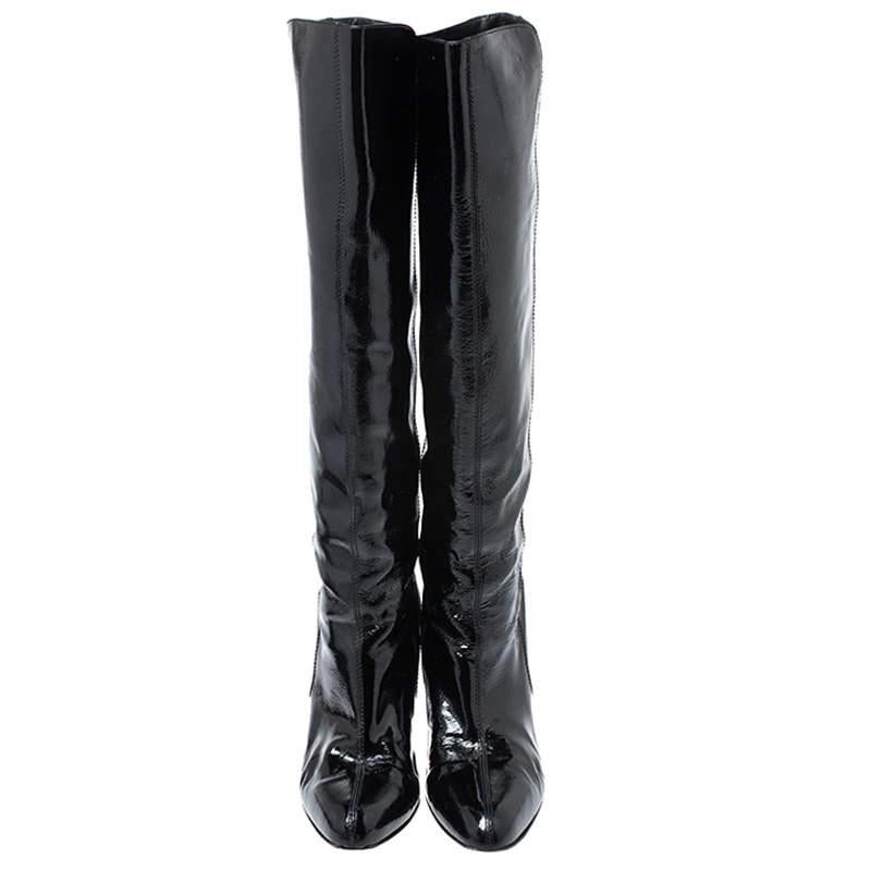 These gorgeous pair of knee-length boots by Salvatore Ferragamo will elevate your closet instantly. Crafted in Italy, this pair is made of glossy patent leather and comes in a classic shade of black. They exude style and sophistication and are great