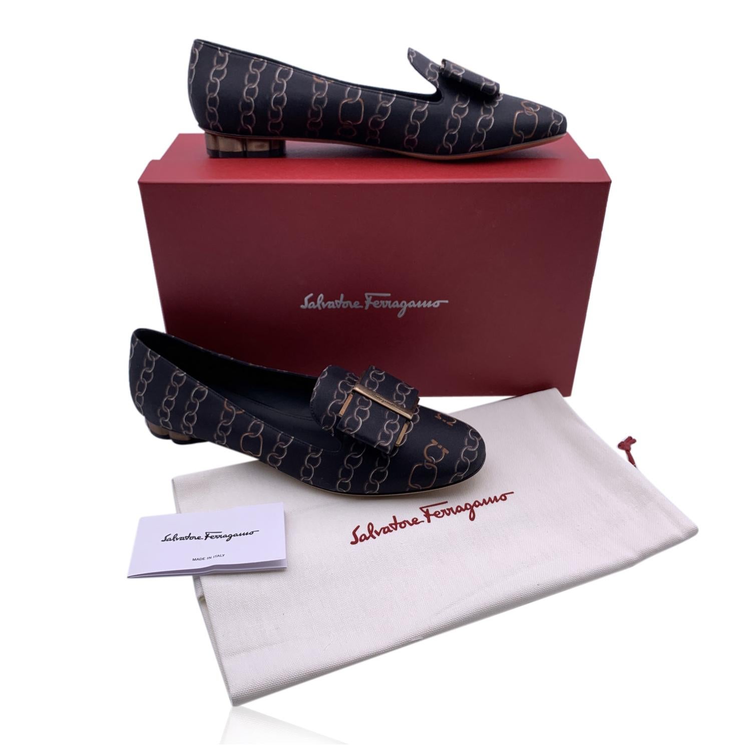 Beautiful Salvatore Ferragamo black fabric 'Sarno Twill' Ballet Flat. Black fabric upper with chain print. They feature a round toe, slip-one design, Vara-bow detailing with gold metal accents on the toes and block flower-shaped heel (height: 1cm).