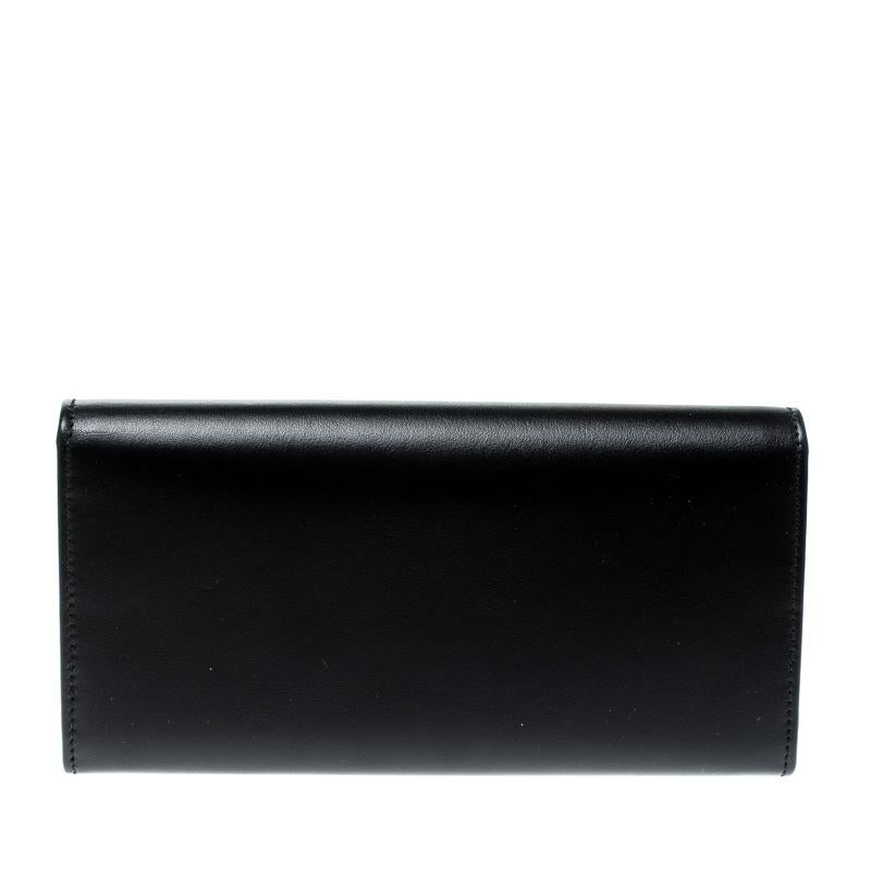 Made of leather in stark black, this continental wallet from Salvatore Ferragamo is a classy choice. The flap with a snap button opens to multiple card slots and a zipped pocket. This wallet is complete with gold-tone studs on the flap.

Includes: