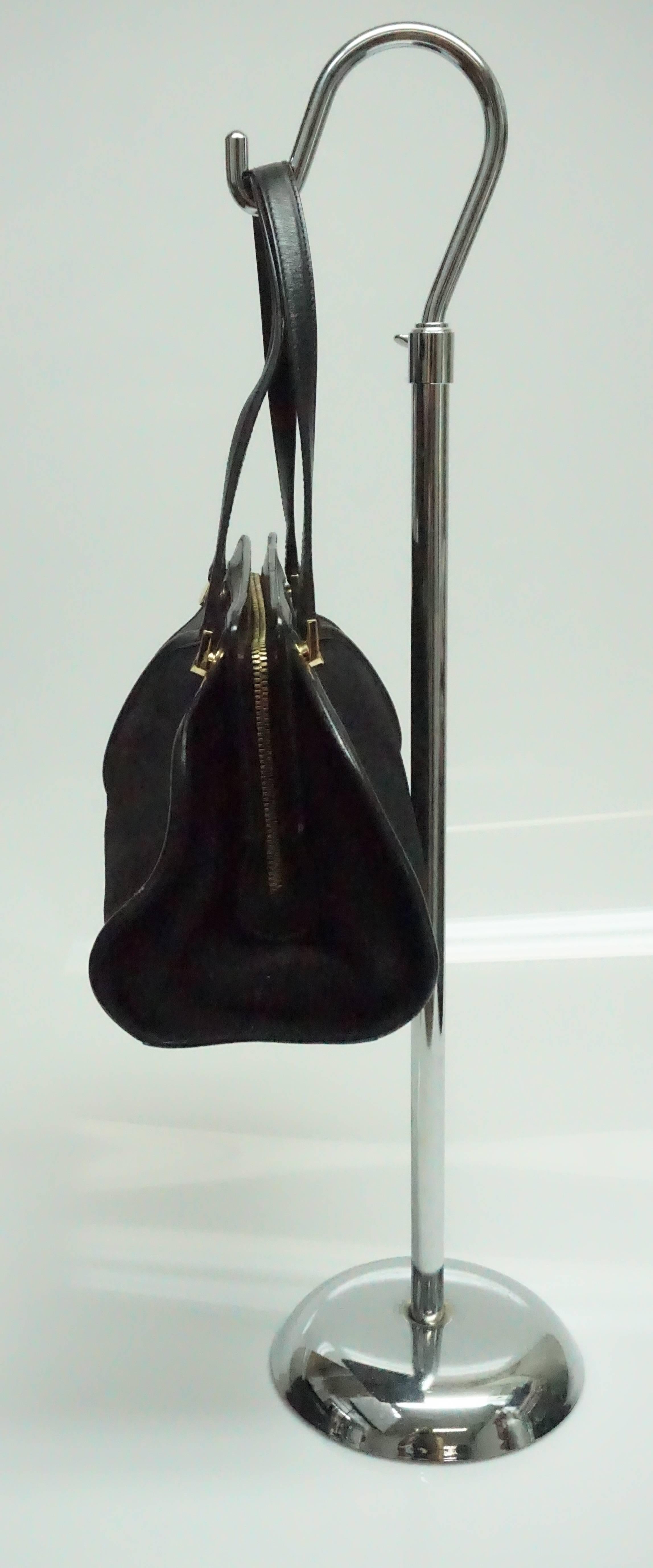 Salvatore Ferragamo Black Suede and Leather Top Handle Handbag  This classic Ferragamo bag is in excellent condition. This purse is mostly black suede with some black leather trimming and gold hardware throughout. The purse has a gold zipper to open