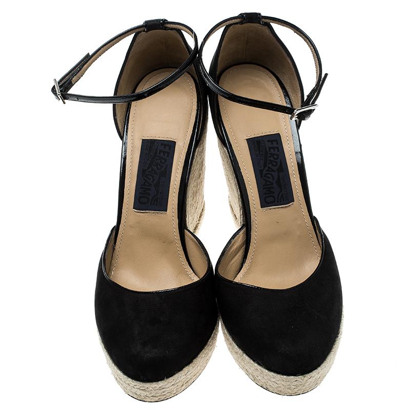 Salvatore Ferragamo's espadrilles are the perfect partner for stylish summertime strolls. Crafted to perfection in black suede with a thin ankle strap fitted with buckle closure, these sandals are elevated on an espadrille-style braided-jute wedge