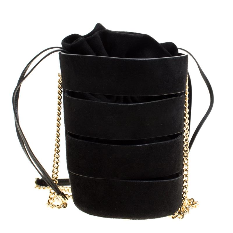 Salvatore Ferragamo's bucket bag will add a stylish element to your wardrobe. Crafted with black leather, it has a soft and interesting structure with cutouts on the exterior and has an open top. This cocktail bucket bag is fitted with a spacious