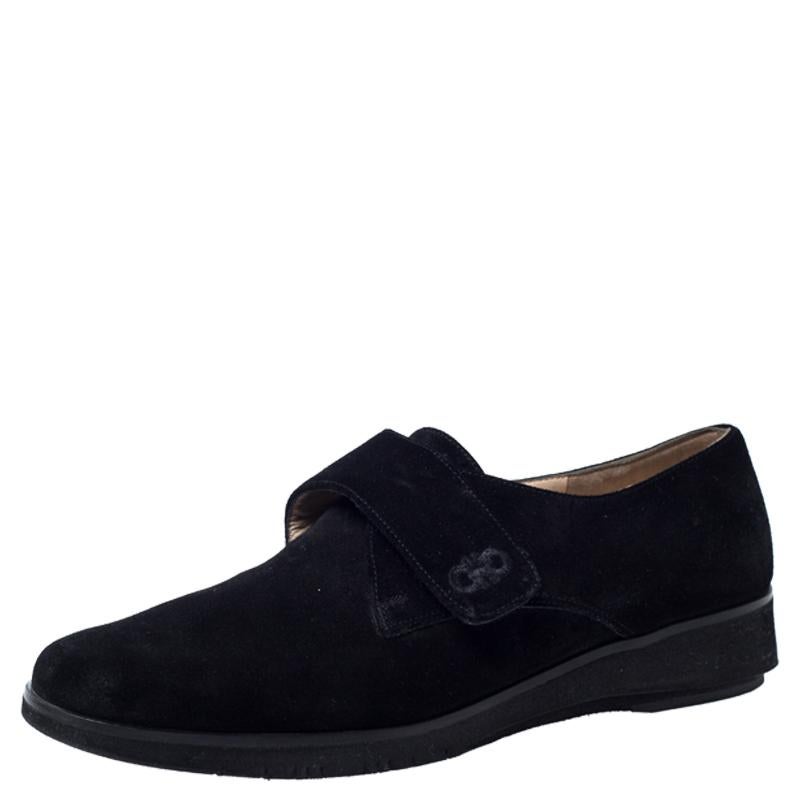 Celebrating the fusion of fine craftsmanship and luxury fashion, these Salvatore Ferragamo shoes are worthy to be worn by you. They bring single velcro straps on the vamps and are so well-crafted with black suede to look fashion-forward. The leather