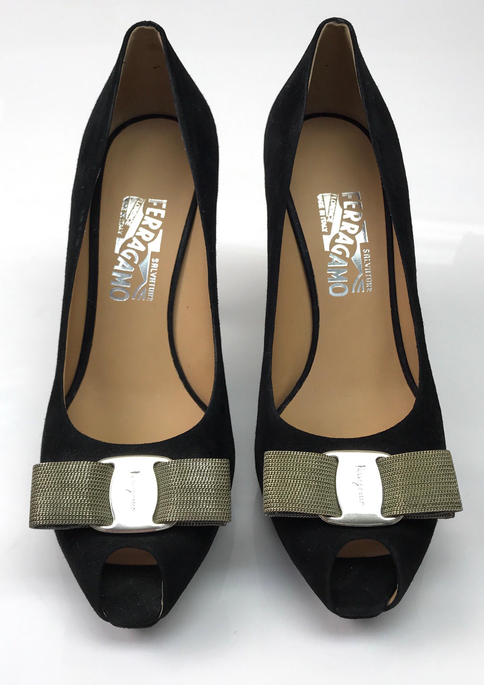 Salvatore Ferragamo Black Suede w/ Silver Chain Bow Pump - 9. This stunning Salvatore Ferragamo pump is in excellent condition. There is no sign of use. It is made of a black suede material and has a peep toe. There is a bow on the front made out of