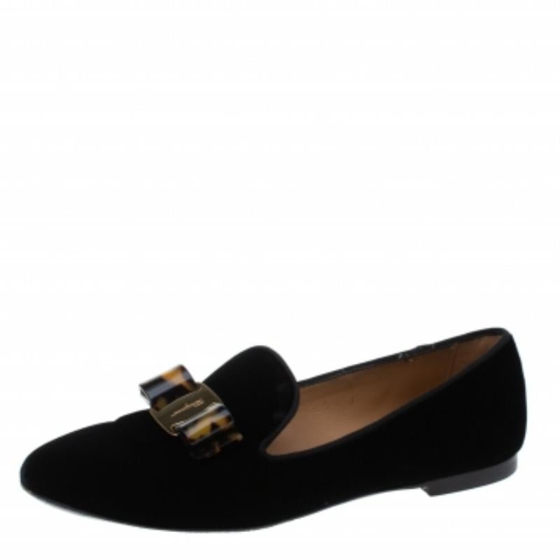 Crafted in black velvet, these Smoking slippers from Salvatore Ferragamo will be your ultimate go-to wear. The shoe comes with a round-toe and rests on a leather sole. It comes with a leather-lined insole and is detailed with the signature bow on