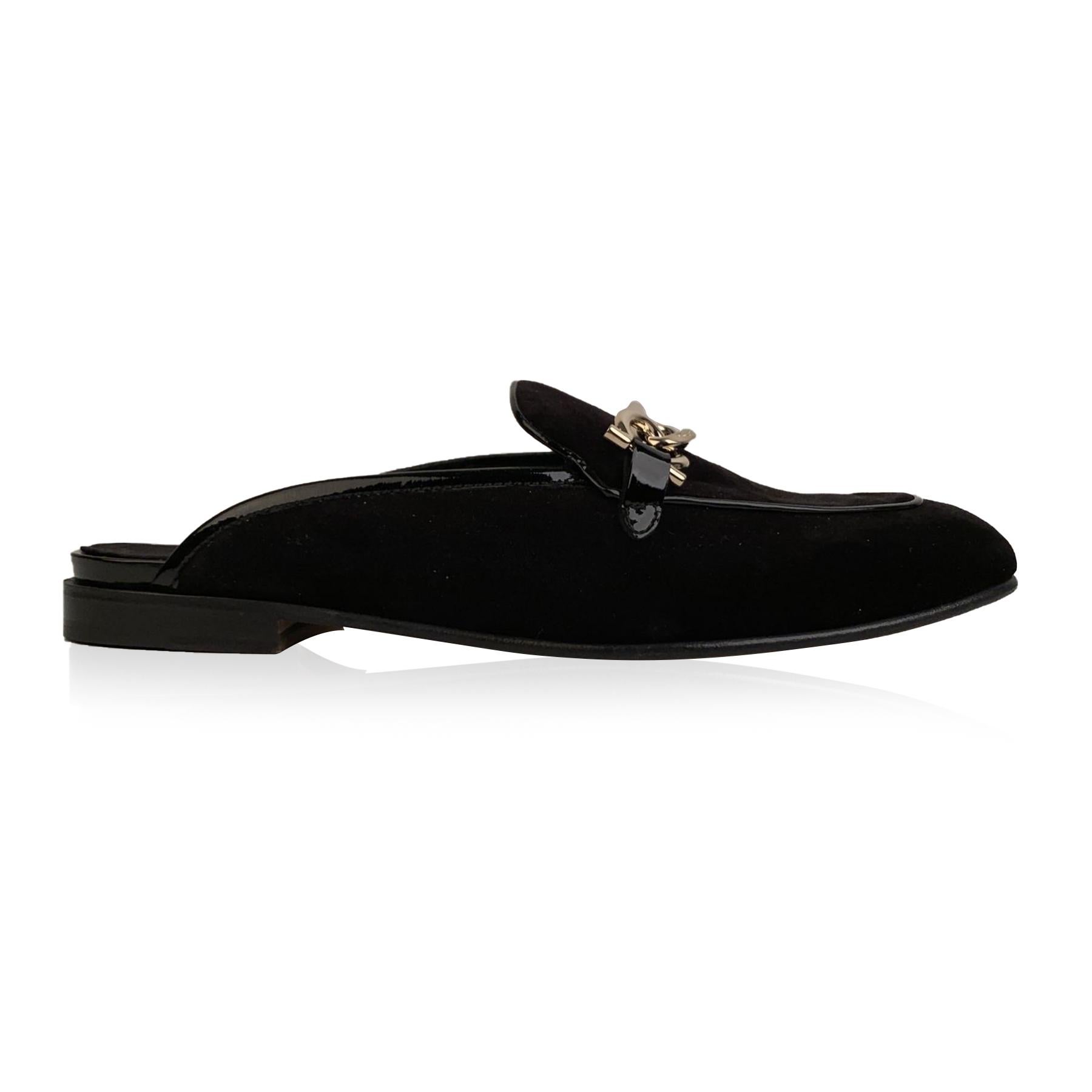 Sophisticated Salvatore Ferragamo 'Girl' mules. Black Velvet upper. They feature a slip-on design, round toe and gold metal chain detailing on the toes. Leather sole. Made in Italy. Size: US 7 C- EU 37.5 C (The size shown for this item is the size