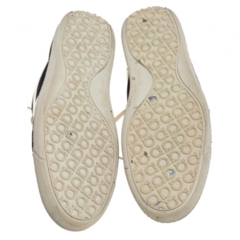 These effortlessly stylish sneakers from Salvatore Ferragamo are meant for sneaker lovers like you! They are crafted from black suede and white leather and designed with round toes, lace-ups on the vamps, and logo details on the sides and the