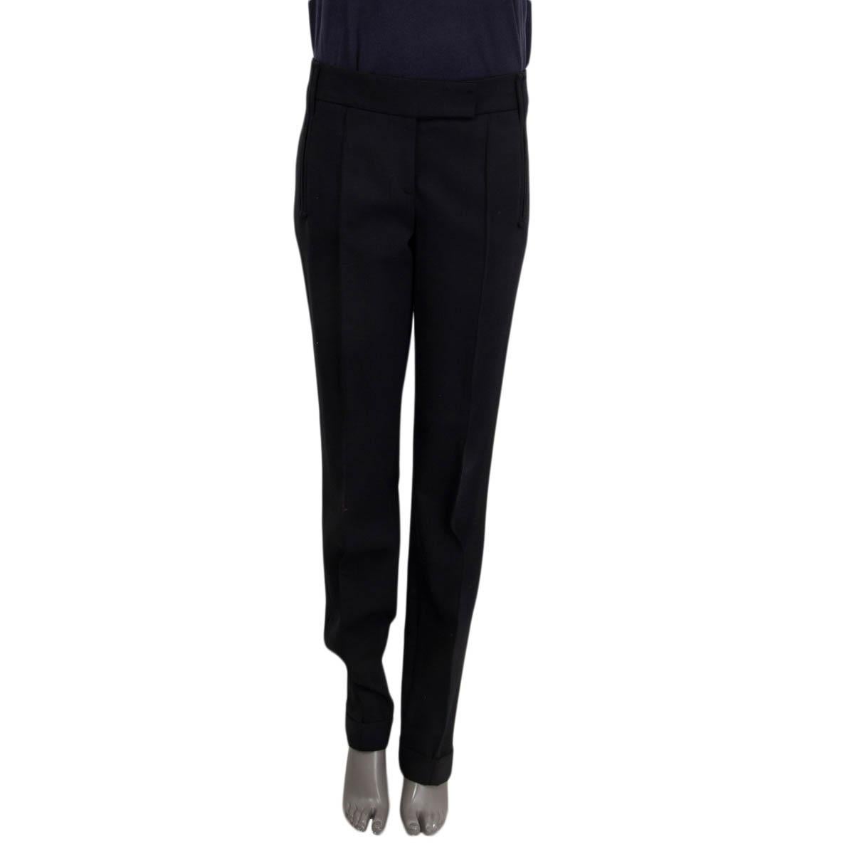 100% authentic Salvatore Ferragamo suit pants in black wool (94%), elastane (5%) and nylon (1%). Features belt loops, two faux slit pockets on the front and two faux slit pockets on the back. Opens with a concealed hook, button and zipper on the