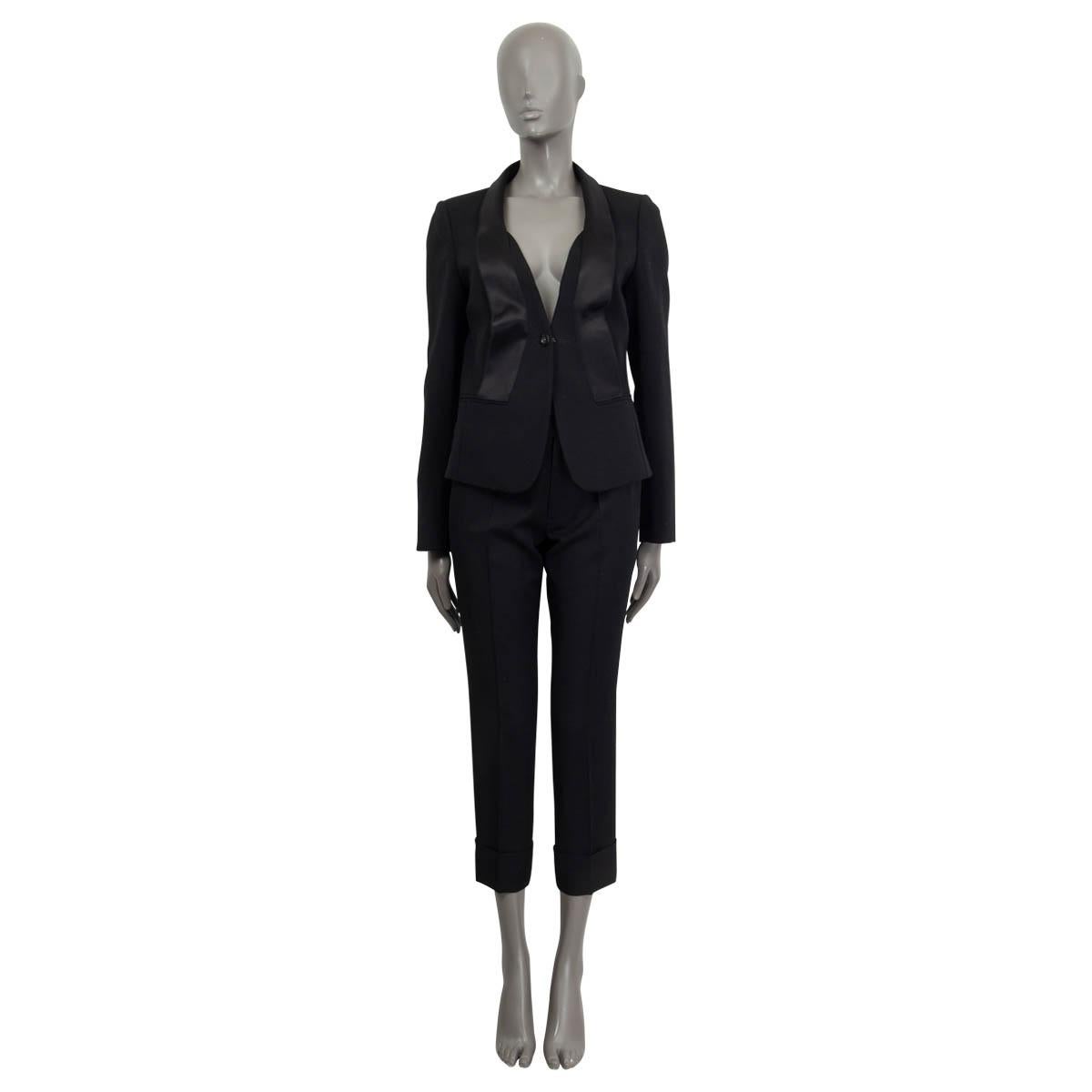 100% authentic Salvatore Ferragamo blazer in black wool (94%), spandex (5%) and nylon (1%). Features a black satin shawl collar and two faux slit pockets on the front. Opens with one button on the front. Lined in black silk (100%). Has been worn and