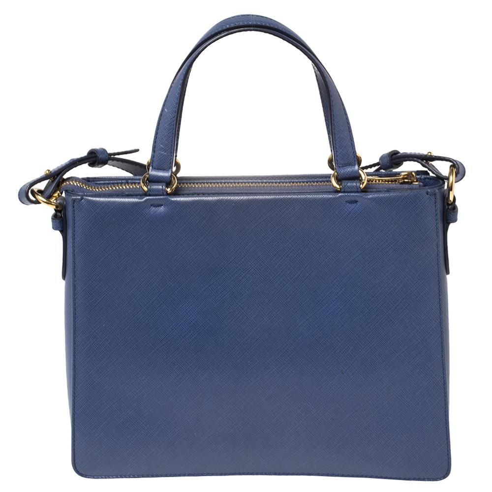Crafted to perfection with leather, this blue tote from Salvatore Ferragamo will help you make a statement effortlessly! Detailed with the signature Vara bow on the front, it carries dual top handles and a spacious interior that is lined with