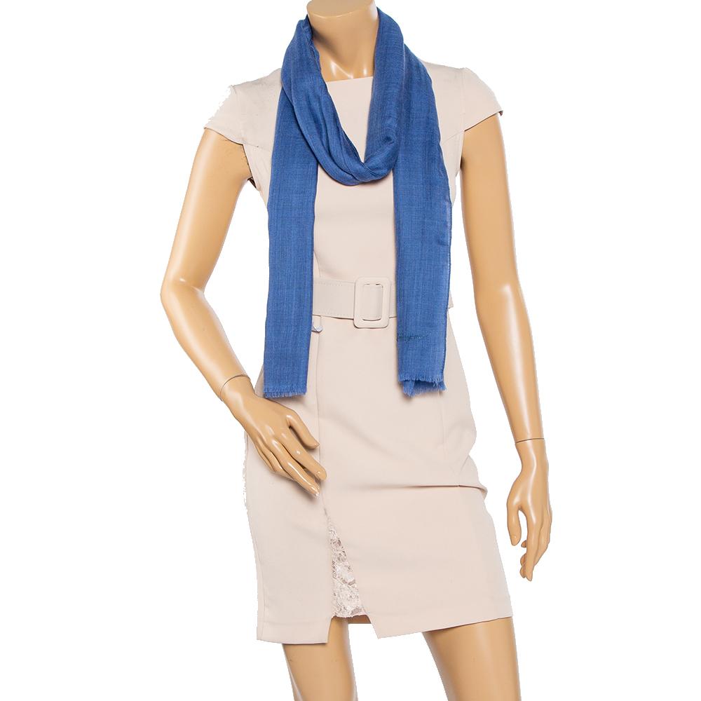 Add this blue Salvatore Ferragamo scarf to your collection for an understated style statement. The scarf is adorned by an embroidered logo. Wear this cashmere scarf on evening occasions or with your special outfits.

Includes: Original Box