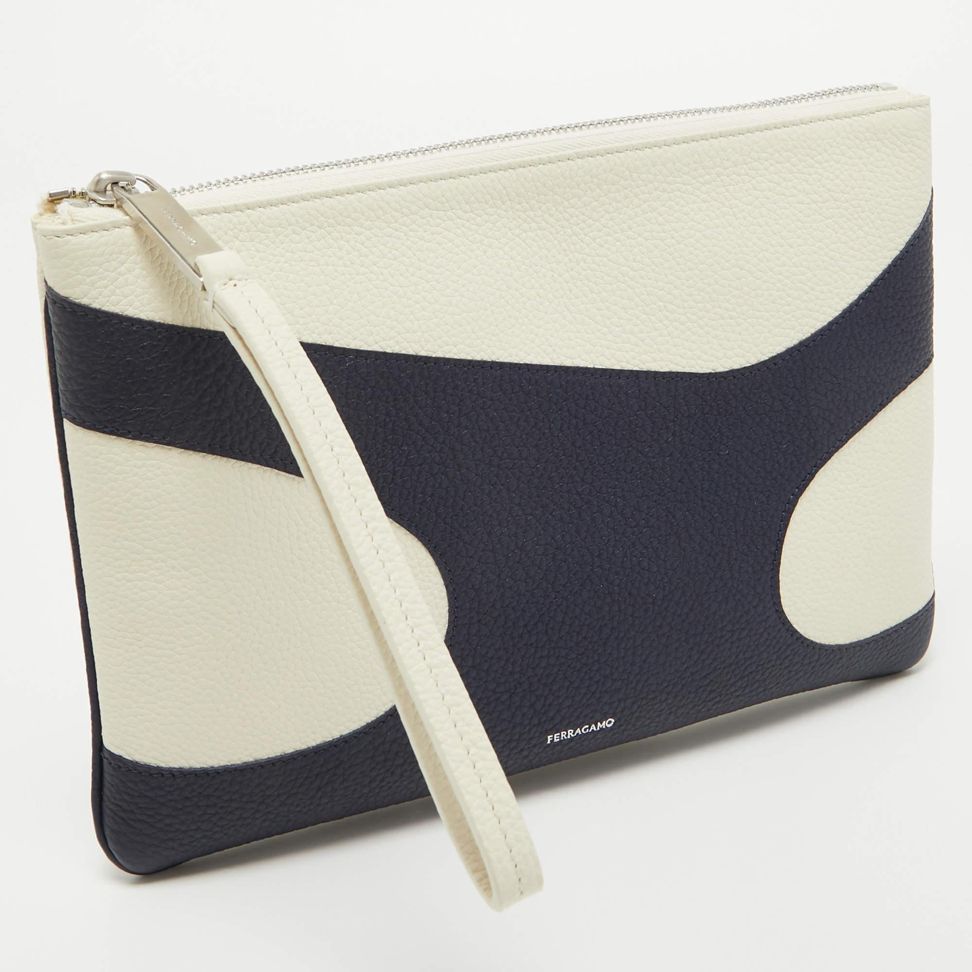 Salvatore Ferragamo marks a signature touch to this pouch. It flaunts the logo on the front and a canvas-lined well sized interior. The pouch can be carried using the wristlet.

