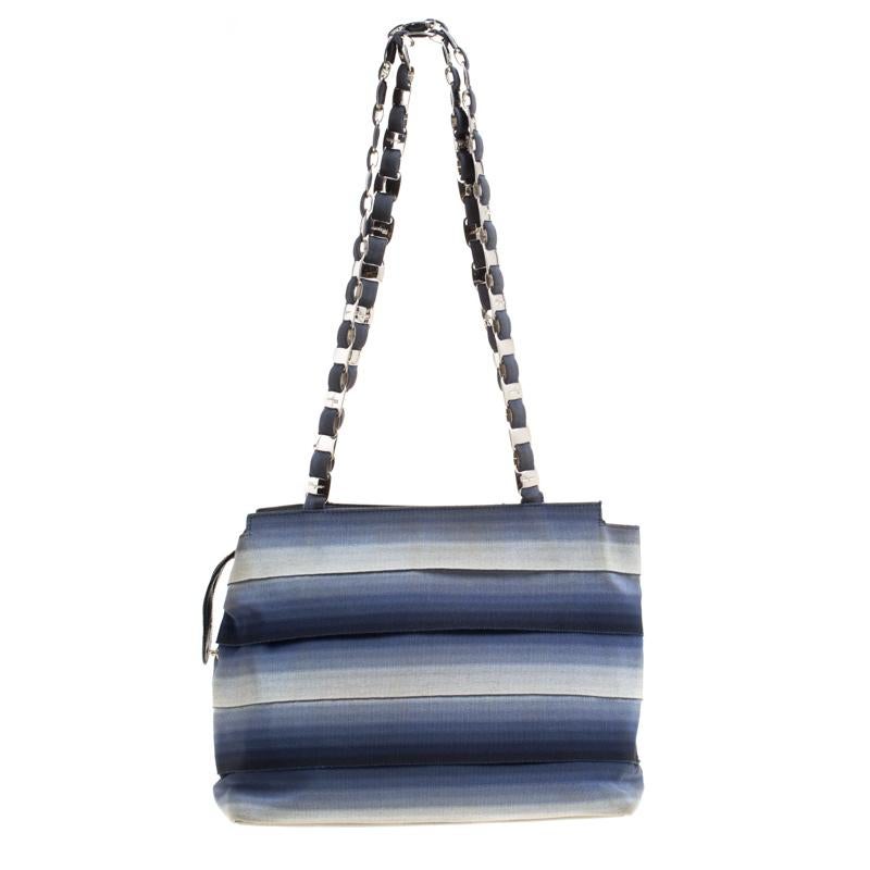 Refurbish your everyday style with this shoulder bag from Salvatore Ferragamo. It features a canvas body beautified with an ombre blue hue. The top zipper opens to a fabric-lined interior which dutifully holds your daily items. Complete with an