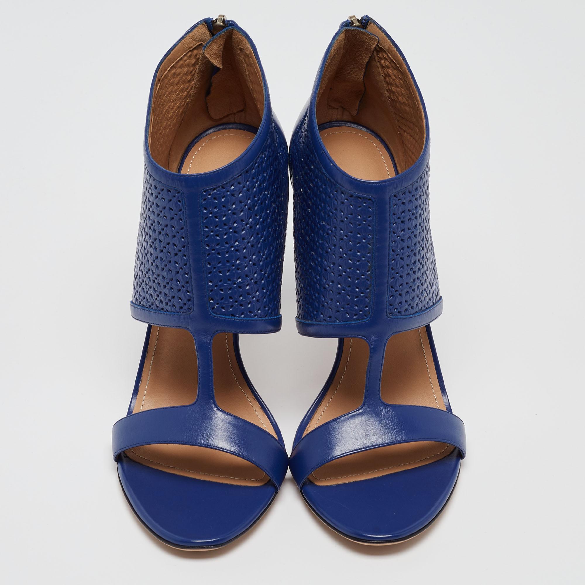 Salvatore Ferragamo blue perforated leather Pacella shoes exude feminine chic with edgy styling. These open toe ankle booties feature a silver tone zipper the back of the toe for a comfortable fit that grazes your ankles. The insoles of these shoes
