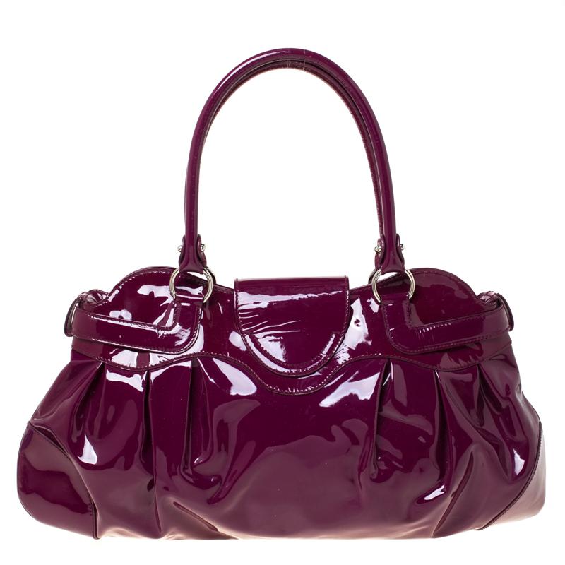 This patent leather bag is a first-class pick for all your essentials. A symbol of style and utility, the bag is lined with fabric and held by two handles. This fabulous satchel by Salvatore Ferragamo will surely fetch you a lot of