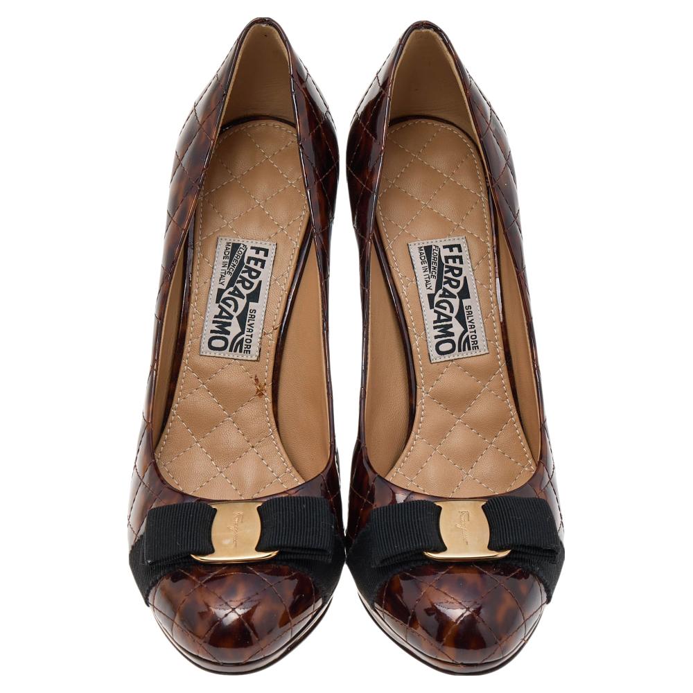 Salvatore Ferragamo's timeless aesthetic and stellar craftsmanship in shoemaking is evident in these versatile Vara Bow pumps. Crafted from brown animal-printed quilted patent leather, they are adorned with the Vara Bow accent on the rounded toes.