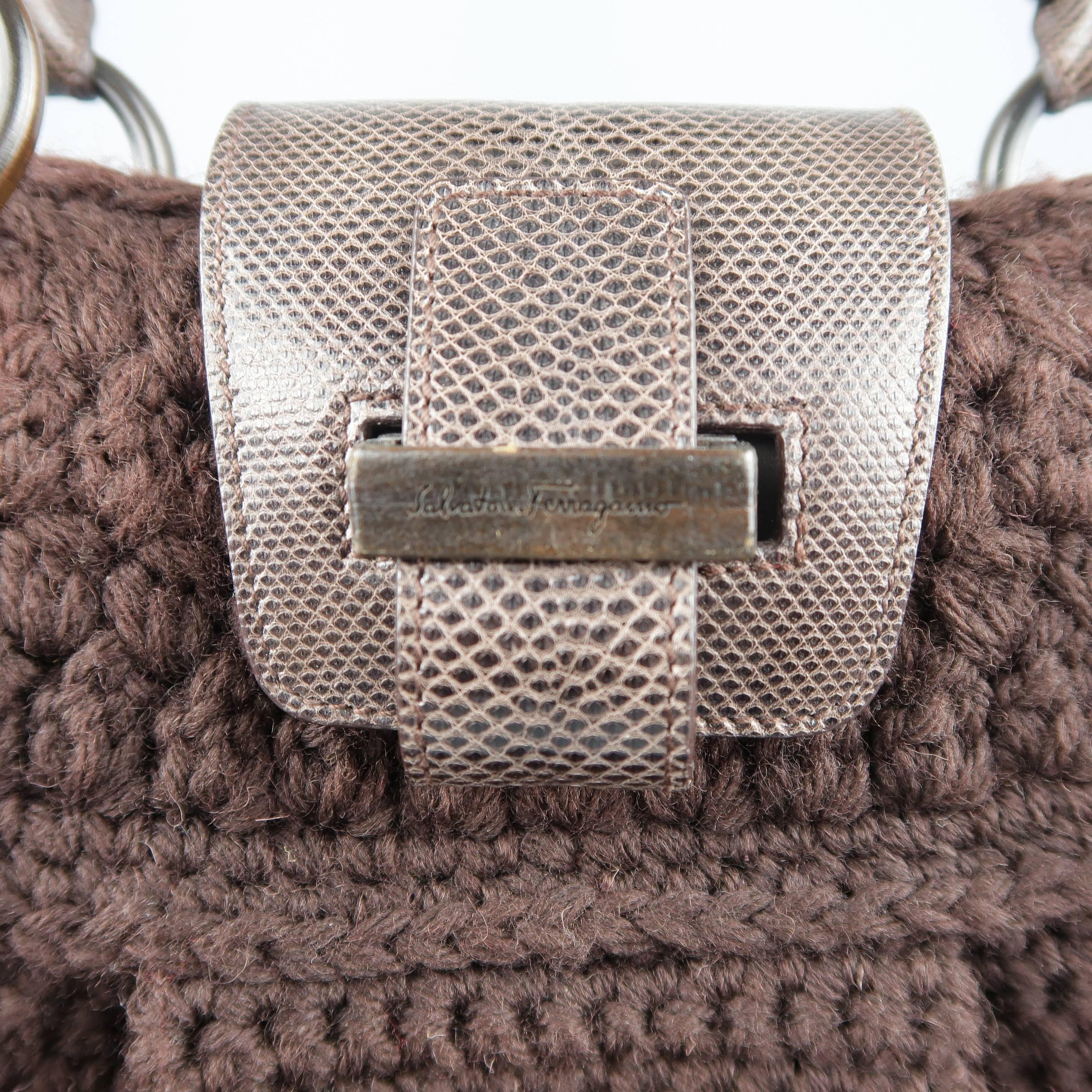 SALVATORE FERRAGAMO shoulder bag comes in a rich brown crochet knit with lizard textured leather details and features a pleated front, Gancini hardware side straps, buckle top closure, and double top handles. Wear on top closure hardware. As-is.