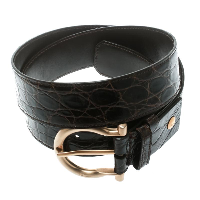 Perfect to add a touch of style to your look, this black leather belt from Salvatore Ferragamo, is crafted in a sleek design with a croc-embossed effect all over. It is styled with a buckle in gold-tone hardware on the front and brand detailing on