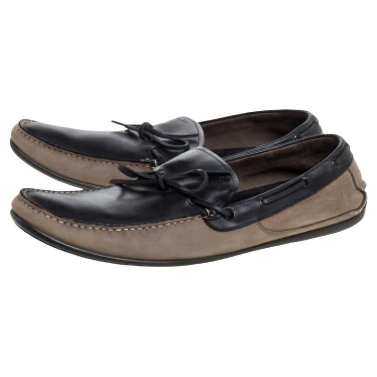 Rock an opulent look by going in for a pair of stylish Salvatore Ferragamo loafers. These brown and grey loafers come crafted from nubuck leather in a slip-on style and feature bows on the vamps. They are equipped with comfortable leather-lined