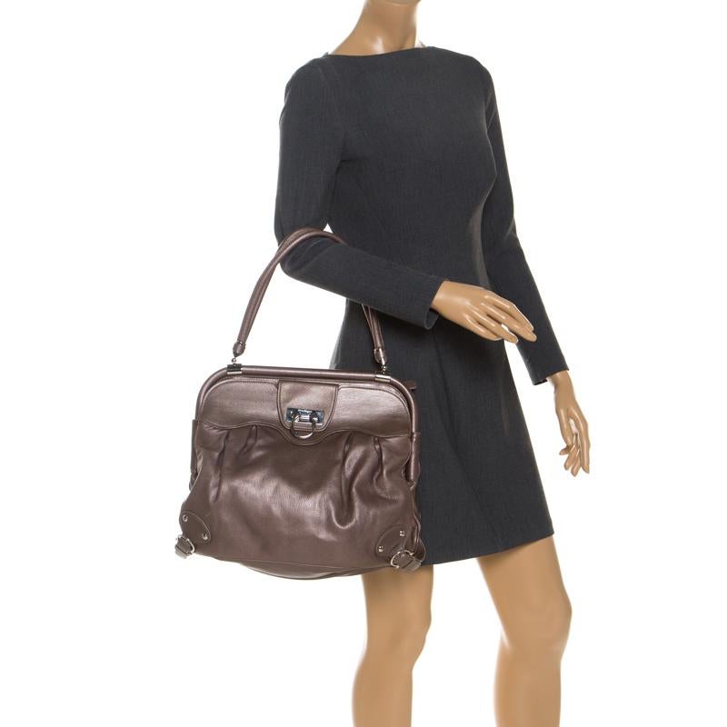 Special days call for special bags, and Salvatore Ferragamo has just the one for you. This gorgeous bag, structured to perfection comes in a brown shade. It is constructed very carefully using quality leather. Inside the fabric interior, there is a