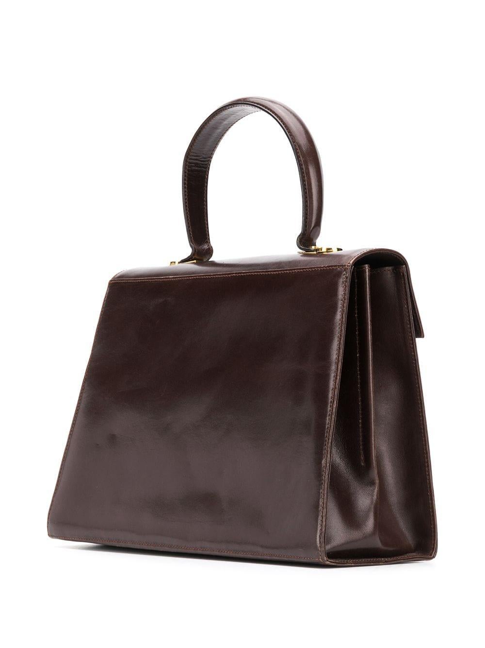 Salvatore Ferragamo brown leather Gancini shoulder bag featuring gold-tone hardware, an internal logo patch, a foldover top, a chain shoulder strap, an internal zipped pocket, a leather lining and a signature Gancini fastening. 
In excellent vintage