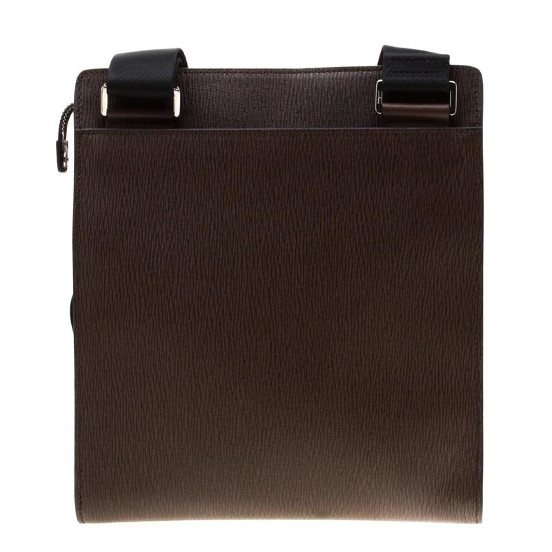 High on style and functionality, this messenger bag from Salvatore Ferragamo is crafted from brown leather. The bag features a single shoulder strap and a front zip pocket. The fabric lined interior is well-sized and houses a zip pocket.

Includes: