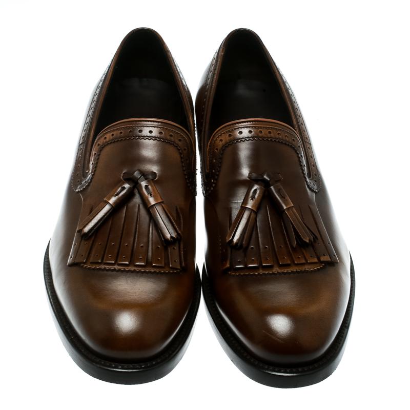 Salvatore Ferragamo brings you these grand loafers that have been created with luxury in mind. They are covered in brown leather and detailed with tassels on the uppers and leather insoles meant to offer comfort in every step. The loafers are a