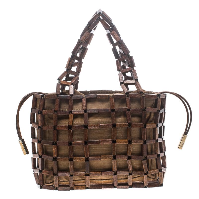 This awesomely unique bag from Salvatore Ferragamo will help you create a stunning style statement. Crafted with the wood in a geometric pattern, like a basket, this bag has similar wooden hands and a fabric-lined spacious interior that will stow