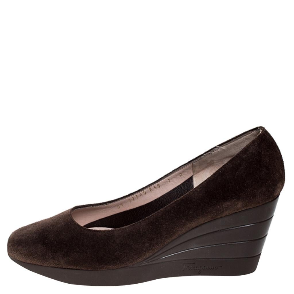 These wedge pumps by Salvatore Ferragamo are a go-to staple style. Designed with brown suede, the relaxed pumps are cut in a simple style. The wedge heel adds to the comfort. The pumps are lined with leather and set on rubber soles.

Includes: