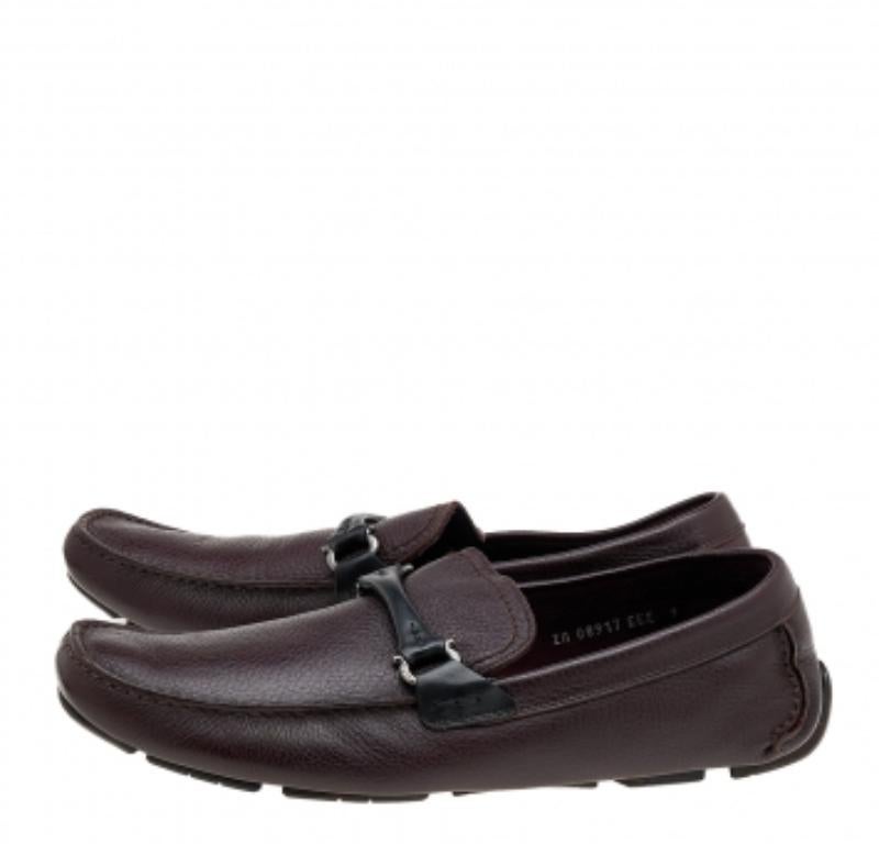 These loafers from Salvatore Ferragamo will grant your feet complete comfort and luxury! They are created using black-burgundy leather, with a Gancini Bit embellishment on the vamps. They feature an easy slip-on style. Complement these loafers with