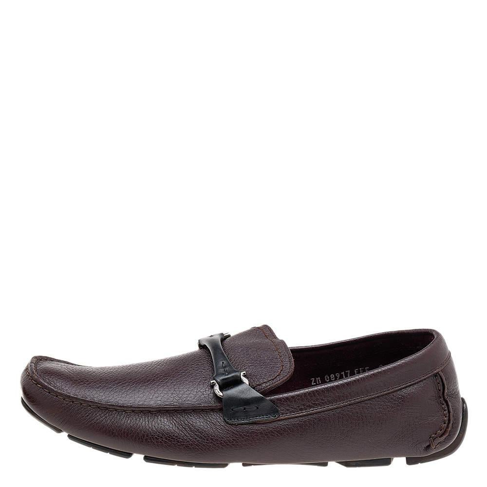 These loafers from Salvatore Ferragamo will grant your feet complete comfort and luxury! They are created using black-burgundy leather, with a Gancini Bit embellishment on the vamps. They feature an easy slip-on style. Complement these loafers with